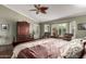 Inviting primary bedroom offers hardwood floors, bay window with shutters, and dark wood furniture at 8540 W Wescott Dr, Peoria, AZ 85382