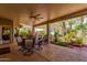 Spacious covered patio with ceiling fan, outdoor seating, and lush landscaping at 8540 W Wescott Dr, Peoria, AZ 85382