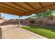 Inviting covered patio with lush lawn and flowering accents creates a tranquil outdoor living space at 8566 N 110Th Ave, Peoria, AZ 85345