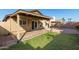 Lush lawn and covered patio create a serene outdoor escape in this private backyard setting at 8566 N 110Th Ave, Peoria, AZ 85345