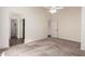 Large bedroom with plush carpet features a ceiling fan, and bathroom and closet access at 8566 N 110Th Ave, Peoria, AZ 85345