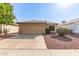 Charming single story home showcasing a two-car garage and low maintenance desert landscaping at 8566 N 110Th Ave, Peoria, AZ 85345