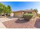 Charming single story home showcasing a two-car garage and low maintenance desert landscaping at 8566 N 110Th Ave, Peoria, AZ 85345