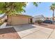 Charming single story home showcasing a two-car garage and low maintenance desert landscaping at 8566 N 110Th Ave, Peoria, AZ 85345
