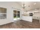 Bright eat-in kitchen features white cabinets, stainless appliances, and sliding glass door to yard at 8566 N 110Th Ave, Peoria, AZ 85345