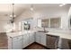 Eat-in kitchen features white cabinets, countertops, stainless appliances, and view to backyard at 8566 N 110Th Ave, Peoria, AZ 85345