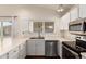 White cabinets and stainless appliances highlight this eat-in kitchen with backyard view at 8566 N 110Th Ave, Peoria, AZ 85345