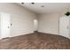 Open-concept living room with hardwood flooring, neutral paint, a ceiling fan and a white front door at 8566 N 110Th Ave, Peoria, AZ 85345