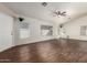 Bright and airy living room featuring modern wood floors, multiple windows, and fresh neutral paint at 8566 N 110Th Ave, Peoria, AZ 85345