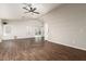 Spacious living room features a ceiling fan, multiple windows, sliding glass doors, and vinyl wood flooring at 8566 N 110Th Ave, Peoria, AZ 85345