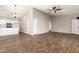 Open concept living room flowing into kitchen with updated flooring, paint, stainless appliances and lighting at 8566 N 110Th Ave, Peoria, AZ 85345