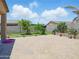 The backyard features a brick paver patio, trees, and plants at 10236 W Wood St, Tolleson, AZ 85353
