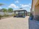 Charming backyard featuring a gazebo, dining set, brick pavers, and well-kept landscaping for outdoor enjoyment at 10236 W Wood St, Tolleson, AZ 85353