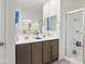 The bathroom features modern fixtures, wood cabinets, a tub/shower combo, and tiled floors at 10236 W Wood St, Tolleson, AZ 85353