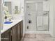 The bathroom features modern fixtures, wood cabinets, and a tub/shower combo, a practical design at 10236 W Wood St, Tolleson, AZ 85353