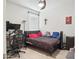 Cozy bedroom featuring a comfortable bed, desk, and ample natural light from the window at 10236 W Wood St, Tolleson, AZ 85353