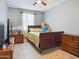 Comfortable bedroom with hardwood floors, warm decor, and a cozy bed perfect for rest at 10236 W Wood St, Tolleson, AZ 85353