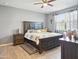The main bedroom features a ceiling fan, side tables, and an expansive bed for a luxurious retreat at 10236 W Wood St, Tolleson, AZ 85353