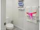 The powder room features a toilet, tiled floors, towels, and modern fixtures for daily convenience at 10236 W Wood St, Tolleson, AZ 85353