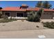Charming single-story home featuring a desert landscaped front yard and a terracotta tile roof at 10580 E San Salvador Dr, Scottsdale, AZ 85258