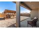 Covered patio and outdoor seating area with a barbecue and gravel yard at 12505 W Kaler Dr, Glendale, AZ 85307