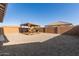 Expansive backyard with ample gravel groundcover and a charming, covered outdoor dining area at 12505 W Kaler Dr, Glendale, AZ 85307