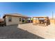 Spacious backyard with a covered patio and a gravel groundcover, perfect for outdoor entertaining and relaxation at 12505 W Kaler Dr, Glendale, AZ 85307