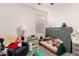 Brightly lit room featuring a chair, rug, bookshelves, toys and large play area at 12505 W Kaler Dr, Glendale, AZ 85307