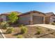 Well-maintained single-story home showcasing desert landscaping, complemented by a two-car garage at 12505 W Kaler Dr, Glendale, AZ 85307