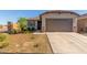 Charming single-story home featuring a low-maintenance yard, inviting curb appeal, and an attached two-car garage at 12505 W Kaler Dr, Glendale, AZ 85307