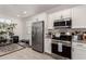 Bright kitchen featuring stainless steel appliances, lots of countertop space, and sleek white cabinetry at 12505 W Kaler Dr, Glendale, AZ 85307