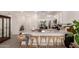Kitchen with a large kitchen island, bar stool seating, stainless steel appliances, and sleek countertops at 12505 W Kaler Dr, Glendale, AZ 85307