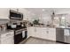 Well-equipped kitchen with stainless steel appliances, granite countertops, and seamlessly connected to the living area at 12505 W Kaler Dr, Glendale, AZ 85307