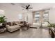 Comfortable living room featuring an open layout, modern ceiling fan, neutral decor, and access to the outdoor patio at 12505 W Kaler Dr, Glendale, AZ 85307