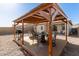 Outdoor patio area featuring table, chairs, grill, and backyard views at 12505 W Kaler Dr, Glendale, AZ 85307