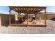 Covered patio with a grill, fire pit, and an outdoor dining set in a spacious backyard at 12505 W Kaler Dr, Glendale, AZ 85307