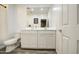 Bright bathroom featuring a double vanity, a toilet, and wood-look tile flooring at 12515 W Marguerite Ave, Avondale, AZ 85323