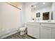 Bright bathroom featuring a double vanity, a toilet, and wood-look tile flooring at 12515 W Marguerite Ave, Avondale, AZ 85323