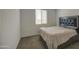 A bedroom featuring a bed, a window with blinds, and a carpeted floor at 12515 W Marguerite Ave, Avondale, AZ 85323
