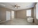 Cozy bedroom with connected ensuite bathroom and ceiling fan at 12515 W Marguerite Ave, Avondale, AZ 85323