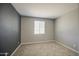 A bedroom featuring neutral walls, a window with blinds, and a carpeted floor at 12515 W Marguerite Ave, Avondale, AZ 85323