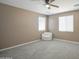 Well-lit bedroom with soft carpet, ceiling fan and a comfortable chair at 12515 W Marguerite Ave, Avondale, AZ 85323