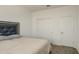 A bedroom featuring a bed, a closet with bi-fold doors, and a carpeted floor at 12515 W Marguerite Ave, Avondale, AZ 85323