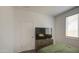 A bedroom featuring a bed, dresser with TV, a window with blinds, and a carpeted floor at 12515 W Marguerite Ave, Avondale, AZ 85323