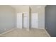 A bedroom featuring neutral walls, a closet with bi-fold doors, and a carpeted floor at 12515 W Marguerite Ave, Avondale, AZ 85323