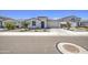 Single-story home featuring a two-car garage, desert landscaping, and a concrete driveway at 12515 W Marguerite Ave, Avondale, AZ 85323