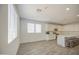 Open-concept kitchen with white cabinetry, stainless appliances, and wood-style flooring at 12515 W Marguerite Ave, Avondale, AZ 85323