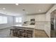 A kitchen island with seating and all-white cabinets at 12515 W Marguerite Ave, Avondale, AZ 85323