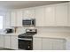 Kitchen features modern appliances and white cabinets at 12515 W Marguerite Ave, Avondale, AZ 85323