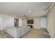 Living room with wood-style tile flooring, a large sectional sofa, and a TV at 12515 W Marguerite Ave, Avondale, AZ 85323